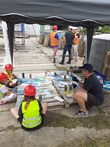 Projektteilnehner mit ihren Entw&uuml;rfen vor den einger&uuml;steten Silos