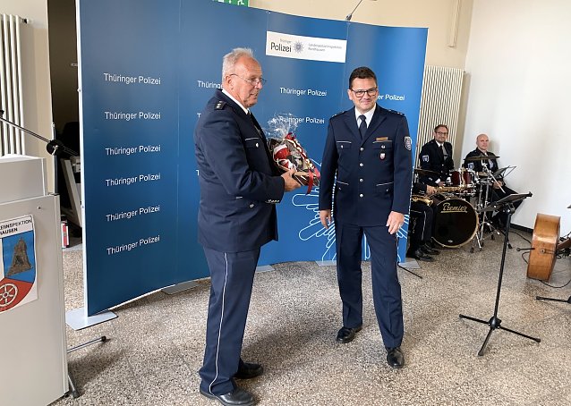 Bild: Polizeidirektor Detlev Schum &uuml;berreicht Ronny Groos (rechts im Bild) sein Pr&auml;sent
