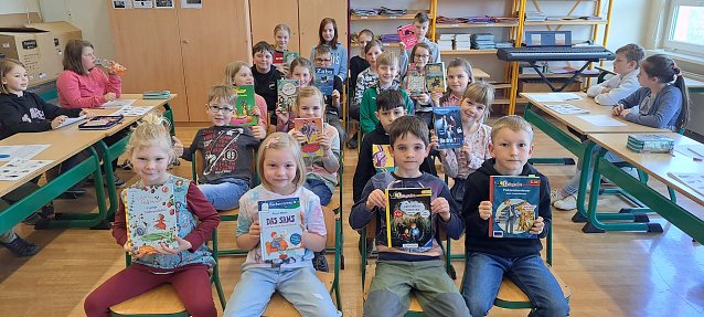 Bild: Die Sch&uuml;lerinnen und Sch&uuml;ler freuen sich nach dem Vorlesewettstreit in der &Ouml;stertal Grundschule  &uuml;ber die gesponserten B&uuml;cher vom Buchh&auml;ndler Rose in Nordhausen