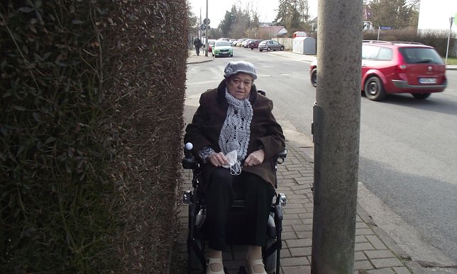 Bild: W&auml;re der Rollstuhl etwas breiter, bliebe die Seniorin zwischen Zaun und Masten eingeklemmt.