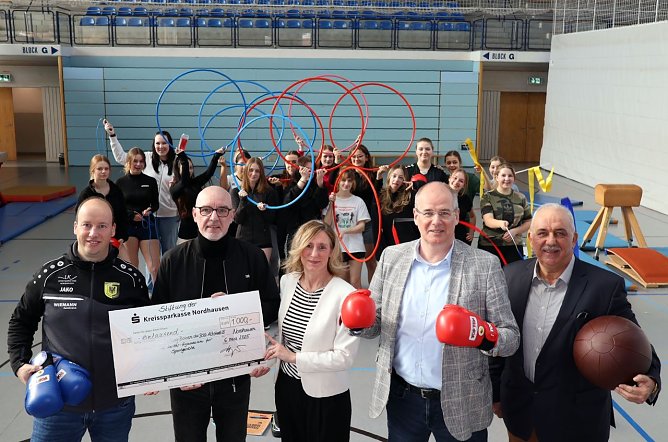 v.l.: Marco Dietrich (BSG Altstadt), Andreas Trump (Schulleiter Herder-Gymnasium), Sandra Hoyer (KSK Nordhausen), Landrat Matthias Jendricke, Werner H&uuml;tcher (Kreissportkoordinator) - im Hintergrund sind Sch&uuml;lerinnen des Herder-Gymnasiums (Foto: Pressestelle Landratsamt)